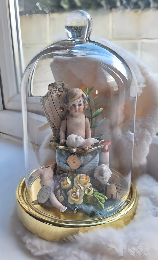 Vintage bisque dolls under glass dome